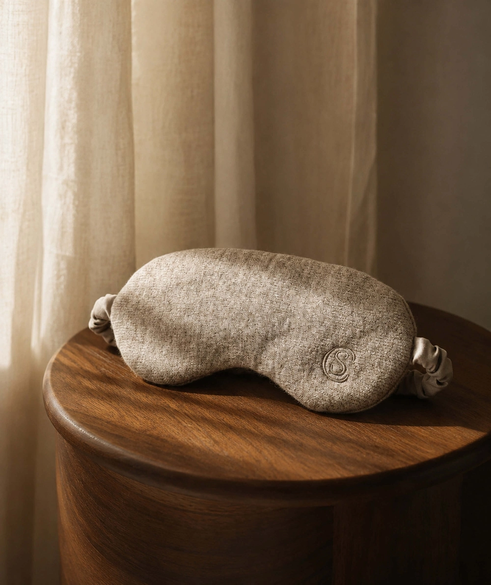 Cashmere Blend Reset Eyemask on a wooden table